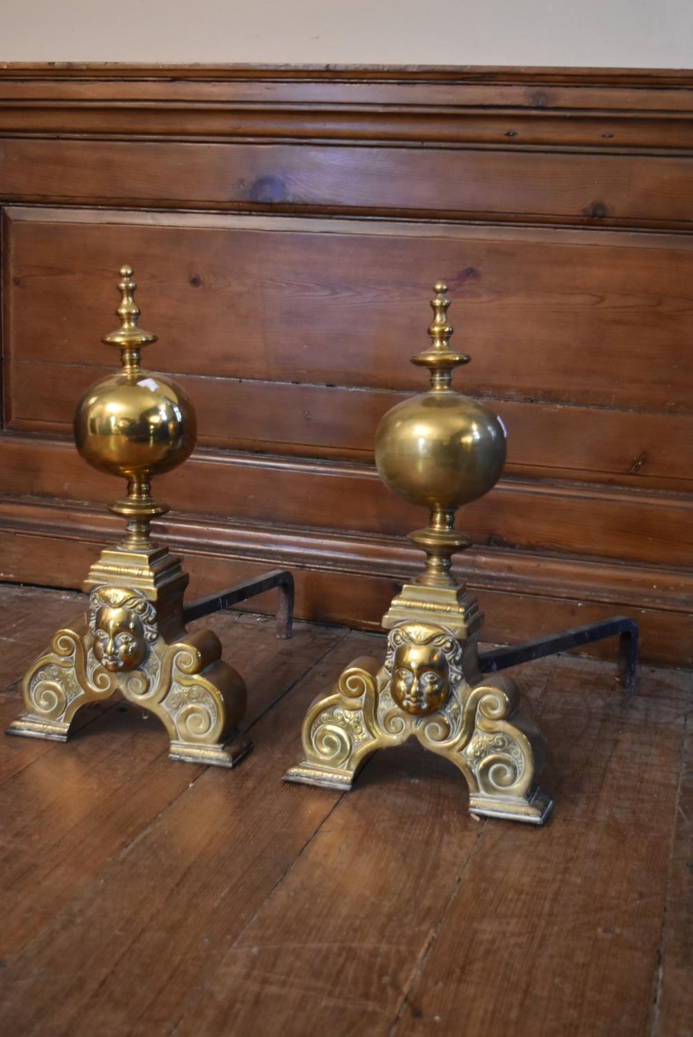 A pair of 19th century brass fire dogs with ball and finials above mask decorated base. H.51 W. - Image 2 of 6