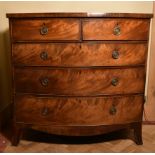 A Georgian flame mahogany bow fronted chest on swept bracket supports.