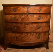 A Georgian flame mahogany bow fronted chest on swept bracket supports.