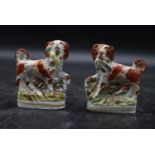 A pair of 19th century flatback Staffordshire pottery tan and white spaniels. H.12 W.9cm (2)