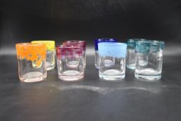 A set of eight Murano style colourful art glass tumblers with speckled design. H.10 Dia.9cm (hand