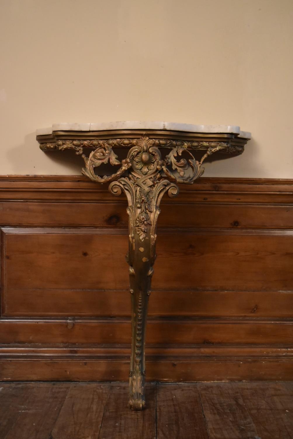 A 19th century giltwood console table with serpentine marble top and scrolling foliate gesso