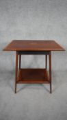 An Edwardian mahogany and satinwood crossbanded occasional table with central fan paterae raised