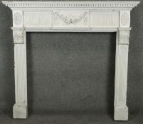 A carved and painted Adam style fire surround with floral swag decoration to the frieze. H.120 W.