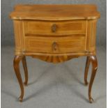 An Italian style walnut and inlaid two drawer chest on cabriole supports. H.76 W.66 D.36cm
