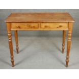 A 19th century pitch pine side table on turned tapering supports. H.73 W.92 D.49cm