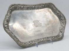 An American repousse silver tray by Theodore B Starr. The edge decorated with a stylised foliate and