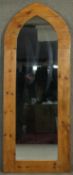 A full height pier mirror in arched pine frame. H.176 W.68cm