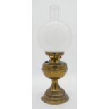 A Duplex brass oil lamp with milk glass globe shade. makers stamp to the wick turner. H.50cm