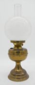 A Duplex brass oil lamp with milk glass globe shade. makers stamp to the wick turner. H.50cm