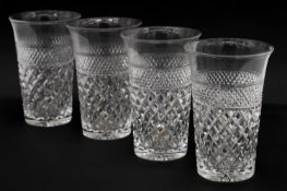 Four heavy hand cut lead crystal water glasses with cross hatched design and star cut base, flared