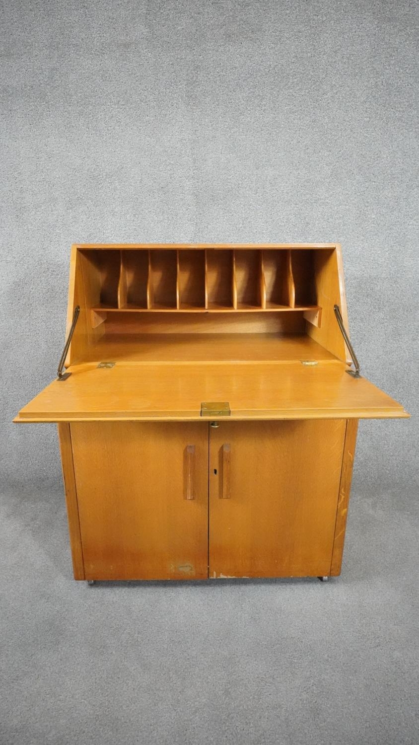 A vintage light oak bureau with fitted interior above panel doors enclosing slides. H.95cm - Image 3 of 5