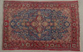 A Persian Isphahan rug with central lozenge medallion on sapphire ground within floral spandrels and