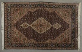 A Tabriz part silk rug with central medallion on floral decorated ground contained by spandrels