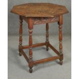 A C.1900 carved oak occasional table in the antique style. H.70 D.68cm