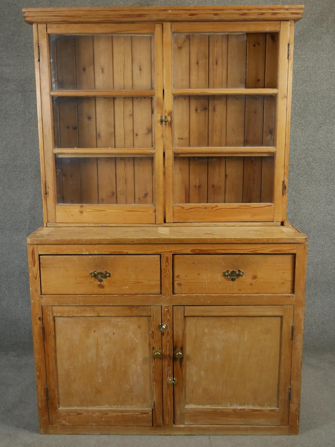 A vintage pine kitchen dresser with glazed upper section above drawers and cupboards. H.186 W.117