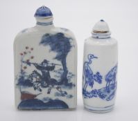 Two Chinese hand painted blue and white porcelain snuff bottles with blue glazed stoppers. One