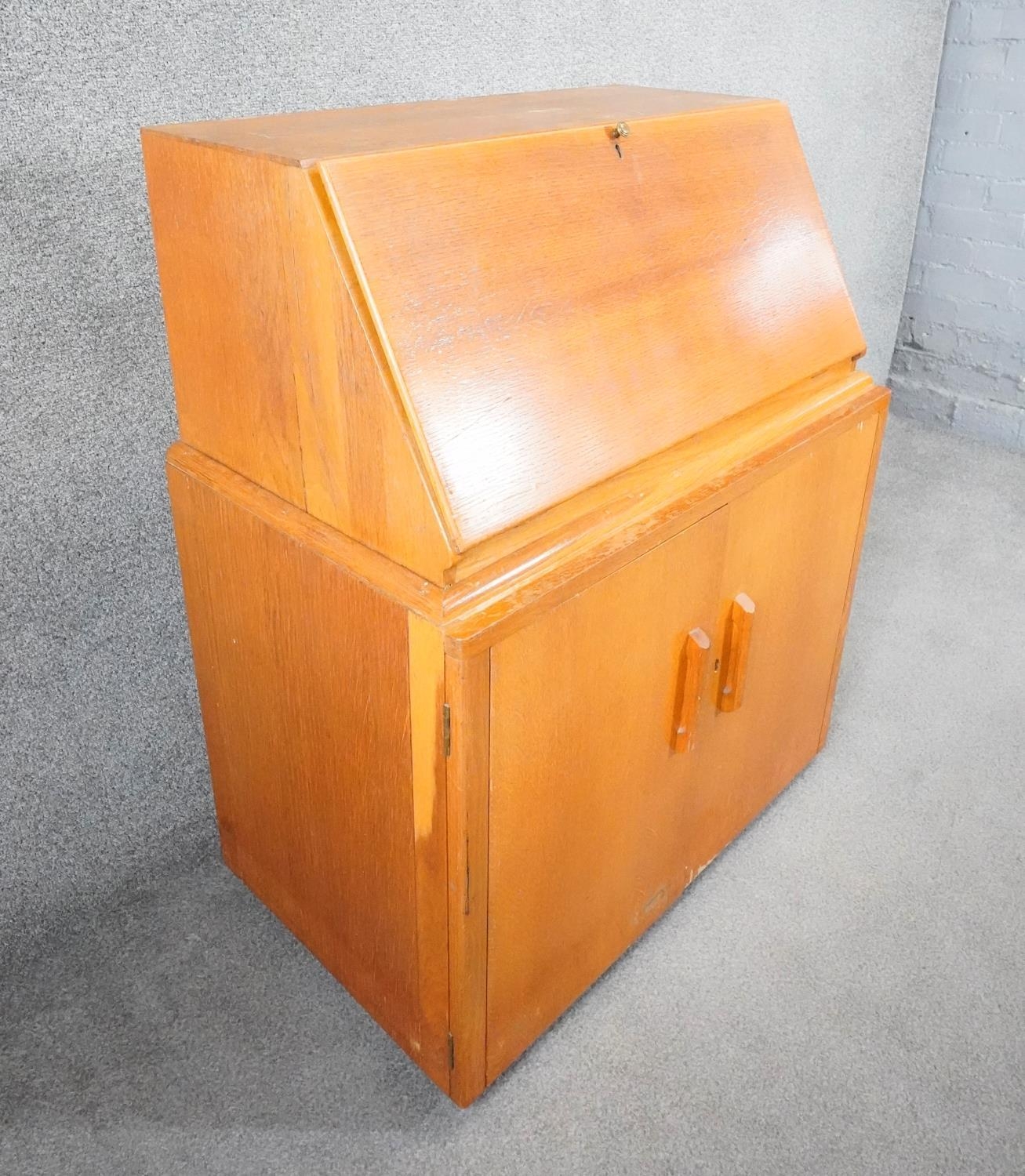 A vintage light oak bureau with fitted interior above panel doors enclosing slides. H.95cm - Image 2 of 5