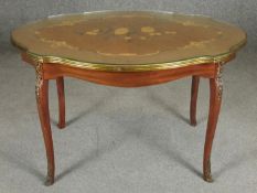 An Italian walnut and floral inlaid occasional table with shaped glass top on ormolu mounted