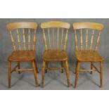 Three 19th century elm seated stick back kitchen chairs. H.84cm