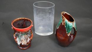 A collection of glass and pottery. Including a clear oval glass vase and two lava glaze pieces. A