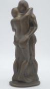 A bronze effect resin sculpture of an embracing couple. Monogrammed ST. H.29cm