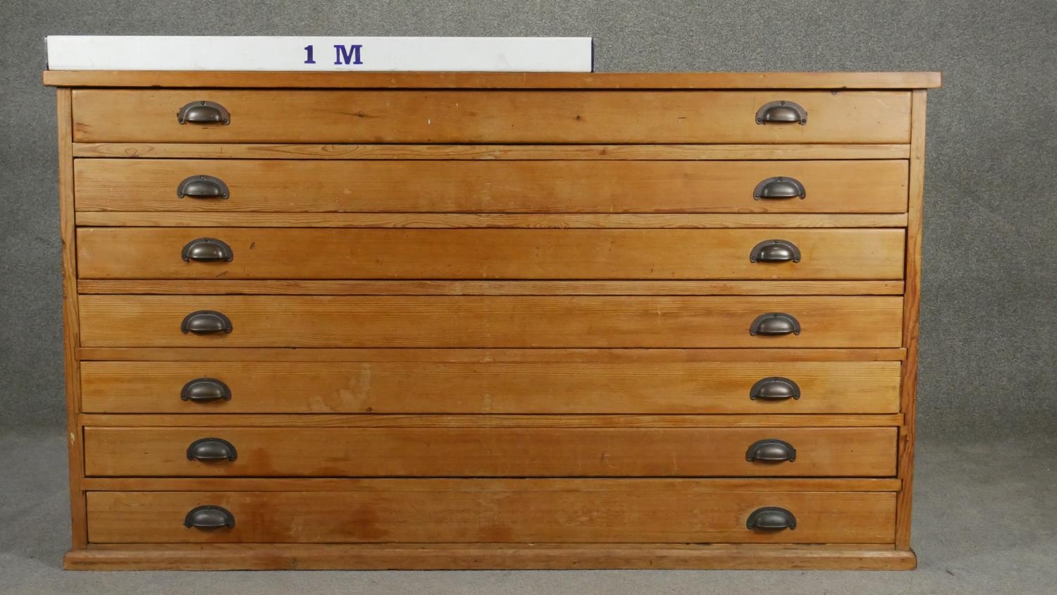 A vintage pine architect's plan chest of seven drawers with brass cup handles. H.94 W.155 D.77cm - Image 4 of 4