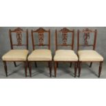 A set of four 19th century oak dining chairs with floral carved splats. H.90cm (one splat damaged as