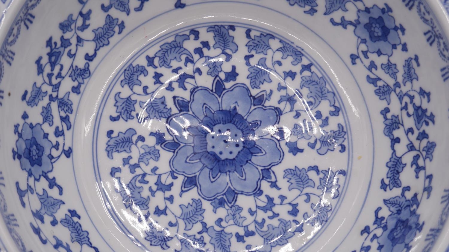 A blue and white Chinese porcelain glazed bowl with stylised floral and foliate design. D.34cm - Image 3 of 6