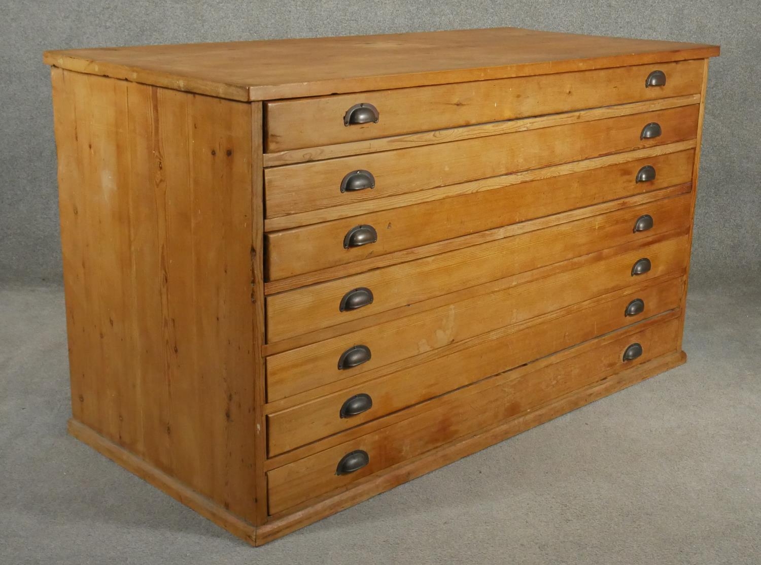 A vintage pine architect's plan chest of seven drawers with brass cup handles. H.94 W.155 D.77cm - Image 2 of 4