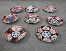 A collection of eight Japanese hand painted Imari plates, decorated with flowers. D.23cm