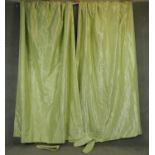 A pair of pale green moire silk taffeta lined curtains. H.265 W.80 W.175cm