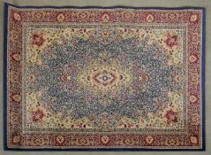 A Kashan style rug with floral central medallion on a pale blue field within foliate spandrels and