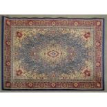 A Kashan style rug with floral central medallion on a pale blue field within foliate spandrels and