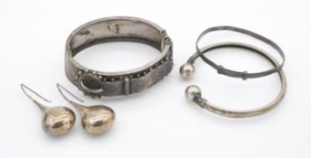 A collection of silver jewellery. Including a Victorian engraved silver belt design bangle with
