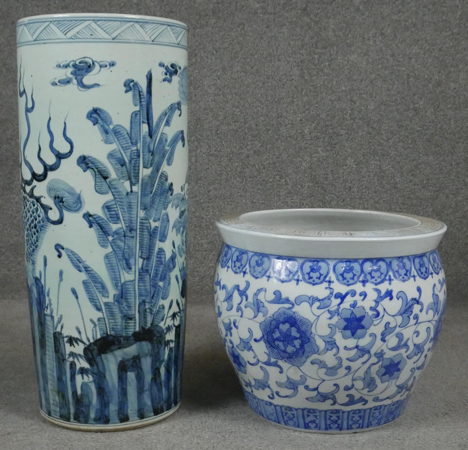 A 20th century Chinese blue and white hand painted umbrella stand decorated with animals and