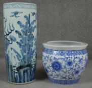 A 20th century Chinese blue and white hand painted umbrella stand decorated with animals and