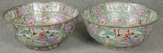 A pair of large footed Chinese famille rose porcelain bowls decorated with figures, flowers and