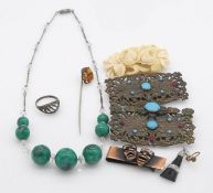 A collection of costume jewellery. Including a pierced brass belt buckle with glass stones, a