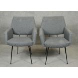 A pair of vintage upholstered armchairs on metal frames. H.84cm (One seat loose as photographed).