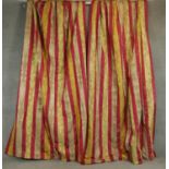 A pair of silk mix red, gold and cream striped lined curtains with a stylised floral and foliate