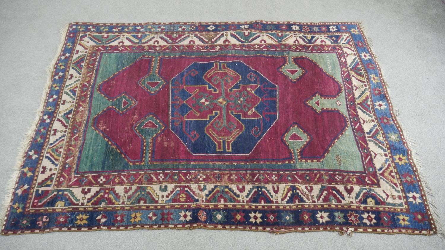 A Kazak rug with central lozenge medallion on burgundy field within jade spandrels (one signed) - Image 2 of 5