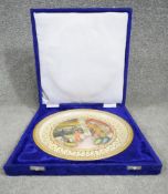 A blue velour cased Indian hand painted and gilded marble plate. Decorated with figures within a