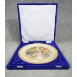 A blue velour cased Indian hand painted and gilded marble plate. Decorated with figures within a