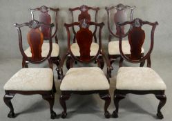 A set of six mahogany early Georgian style dining chairs with shaped shell carved splats above
