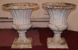 A pair of painted cast iron campana form garden urns. H.50cm