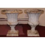 A pair of painted cast iron campana form garden urns. H.50cm