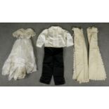 Four Victorian lace and silk christening outfits. One for a little boy with black trousers and three