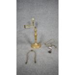 A brass desk lamp with adjustable articulated arm. H.44