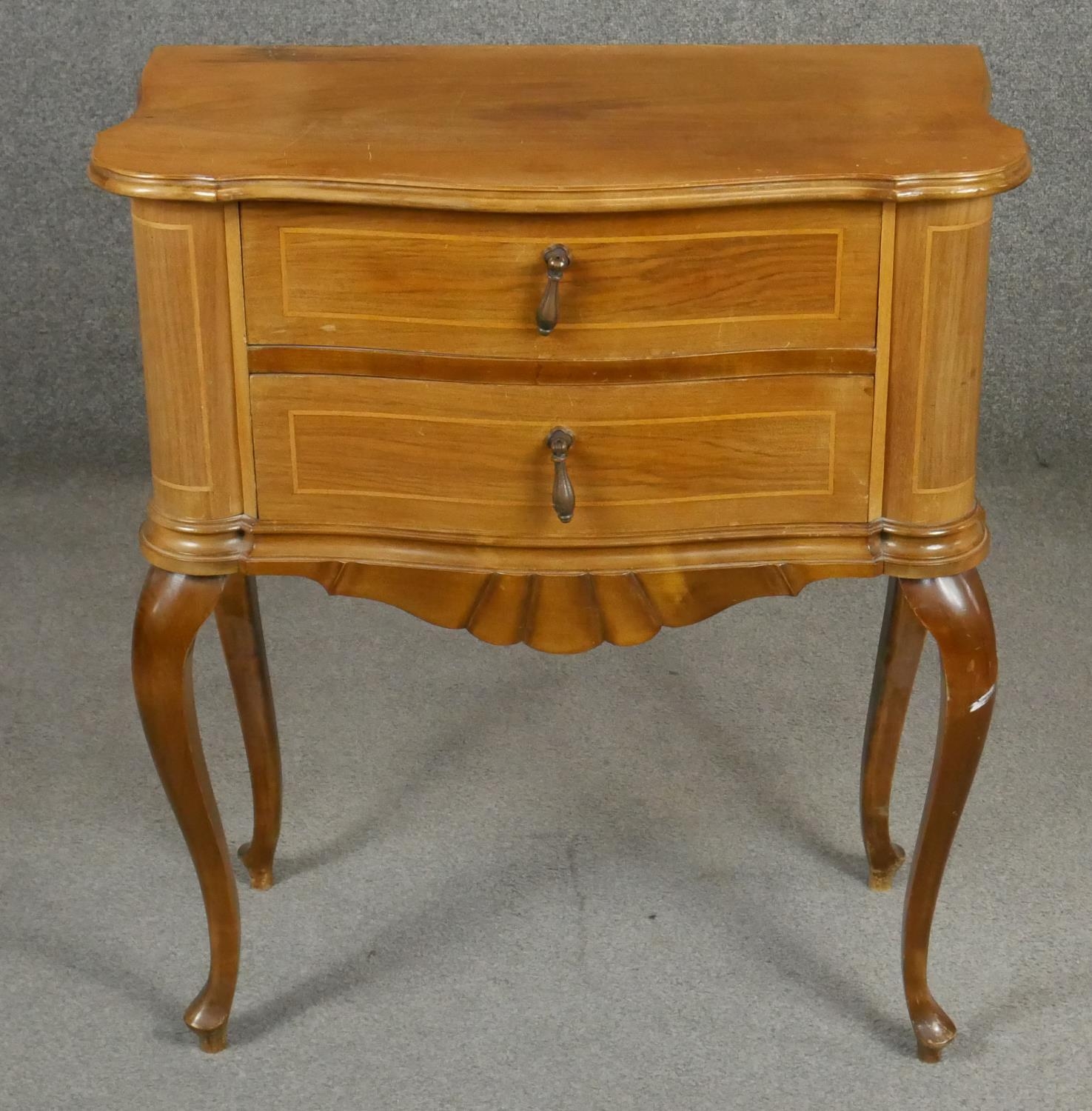 An Italian style walnut and inlaid two drawer chest on cabriole supports. H.76 W.66 D.36cm